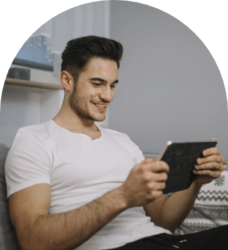 smiling-man-using-tablet-couch (1)